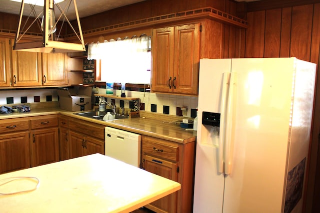 kitchen with sink, white appliances, and backsplash