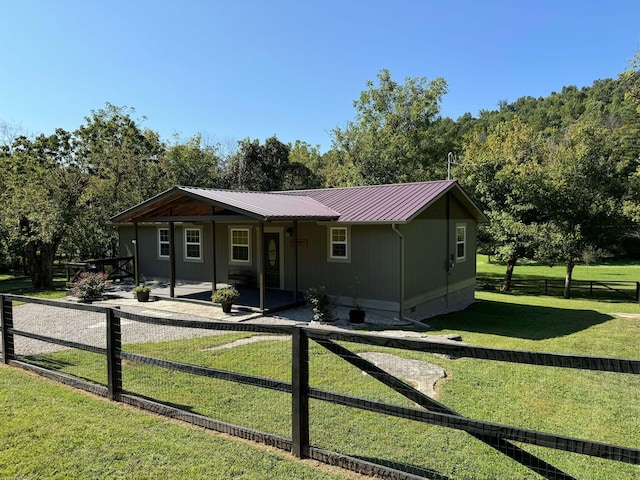 exterior space featuring a front lawn and a patio