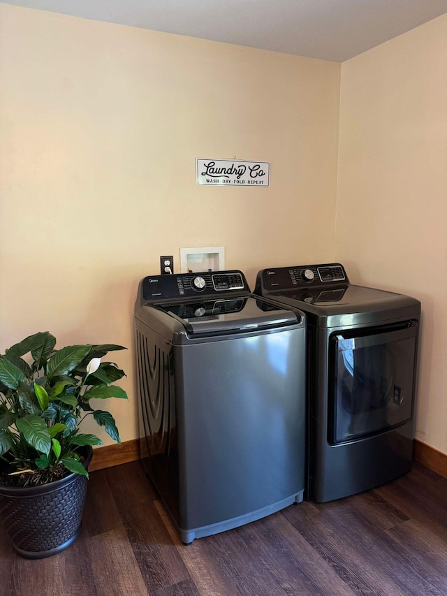 washroom with washing machine and dryer and dark hardwood / wood-style floors