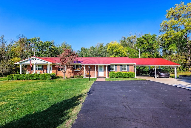 single story home featuring a front lawn, a carport, and covered porch