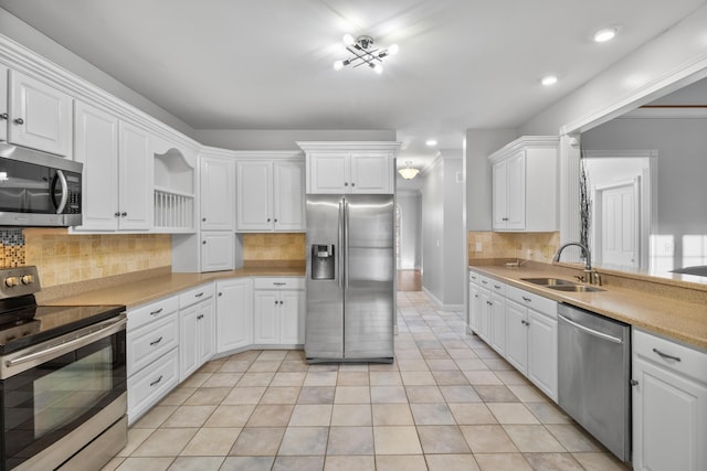 kitchen featuring sink, white cabinets, stainless steel appliances, and light tile patterned floors