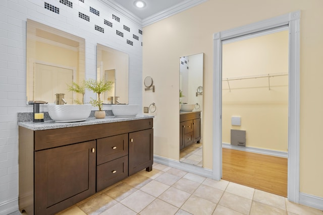 bathroom with tile patterned floors, vanity, and crown molding