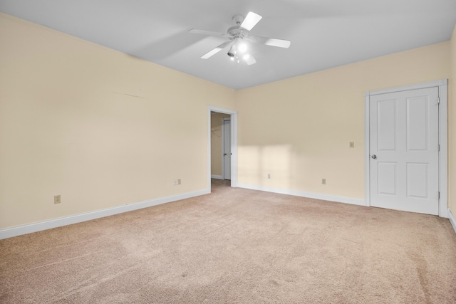 unfurnished room featuring light colored carpet and ceiling fan