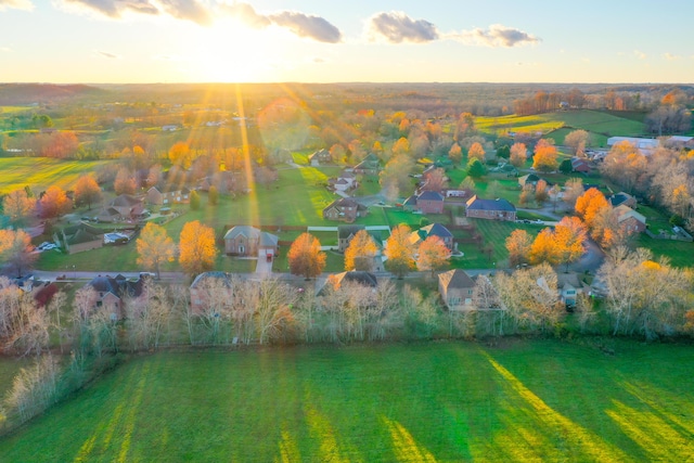 aerial view at dusk with a rural view and a water view