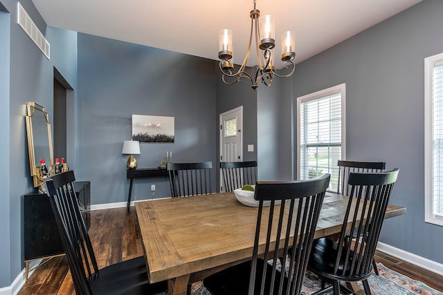 dining room with a notable chandelier and dark hardwood / wood-style floors