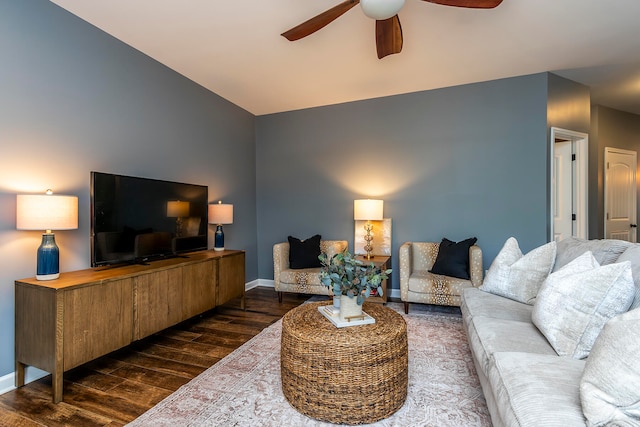 living room with dark hardwood / wood-style flooring and ceiling fan