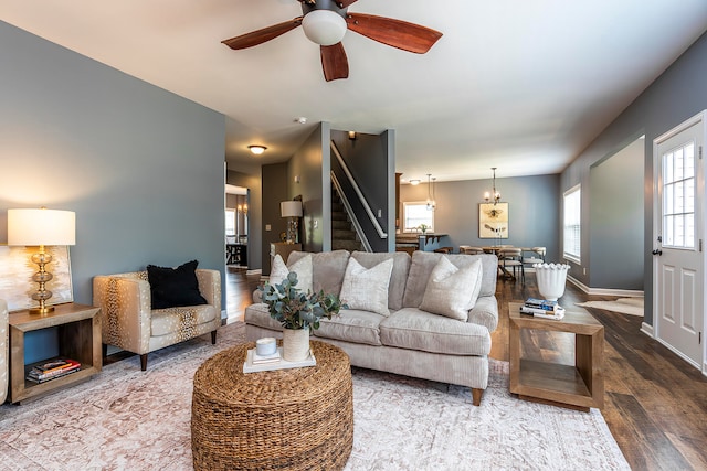 living room with wood-type flooring and ceiling fan