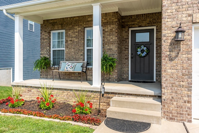 entrance to property featuring covered porch