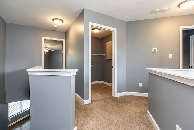 hallway featuring dark colored carpet