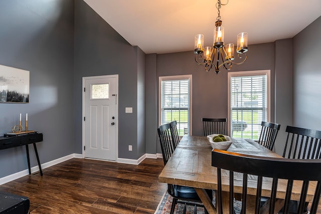 dining space featuring dark hardwood / wood-style flooring and a notable chandelier