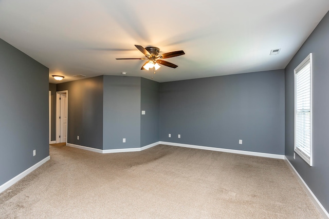 empty room with ceiling fan and carpet