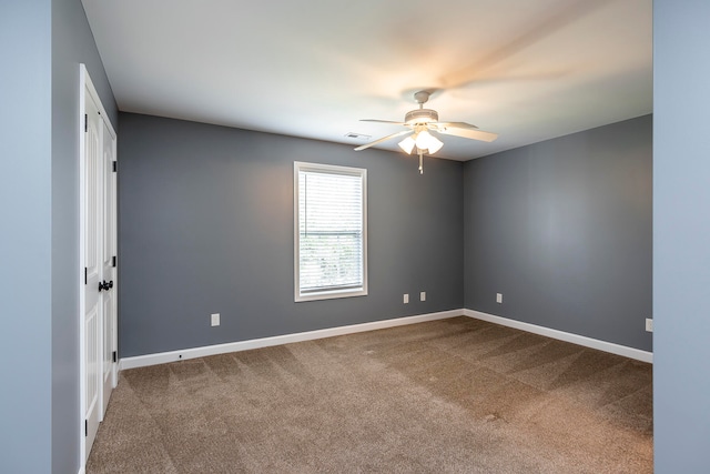 carpeted empty room featuring ceiling fan