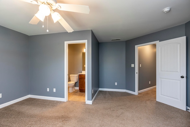 unfurnished bedroom featuring ceiling fan, light colored carpet, and connected bathroom