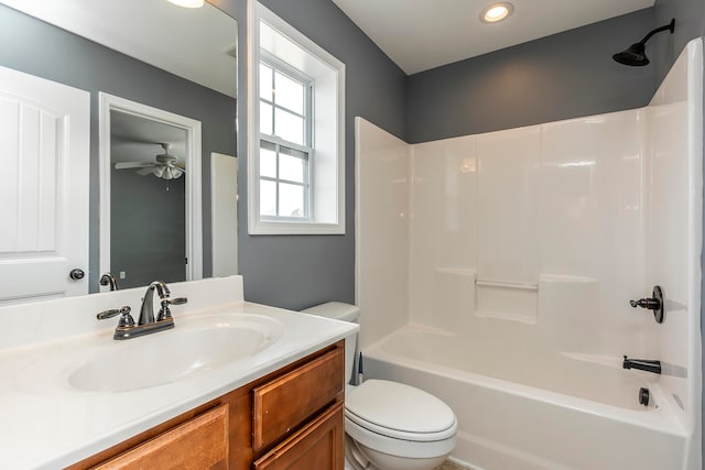 full bathroom with tub / shower combination, vanity, toilet, and ceiling fan