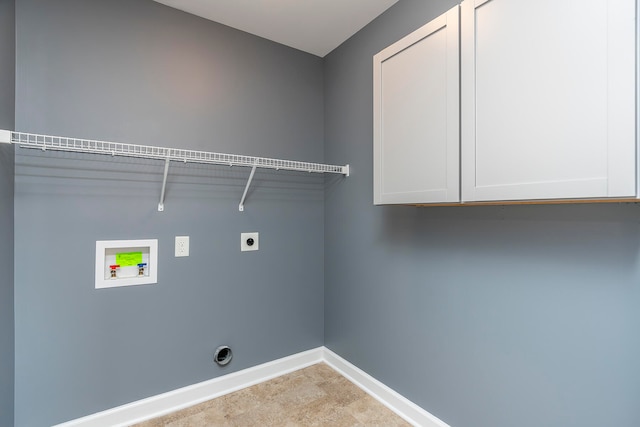 laundry area with hookup for a washing machine, cabinets, and electric dryer hookup