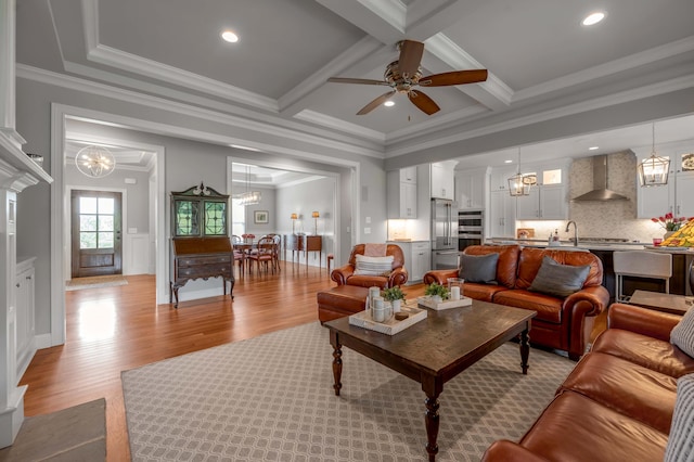 living room featuring beamed ceiling, ornamental molding, coffered ceiling, recessed lighting, and light wood-style floors