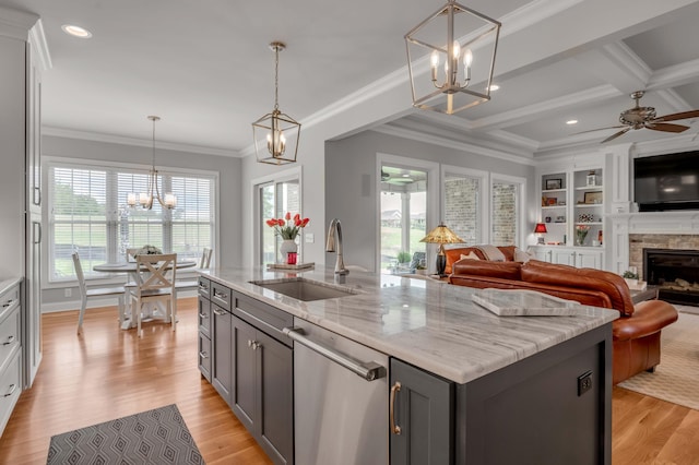 kitchen featuring a sink, gray cabinets, crown molding, and stainless steel dishwasher