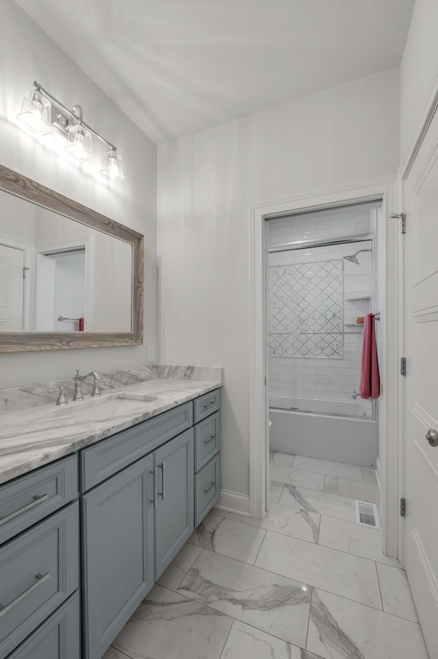 full bath featuring visible vents, marble finish floor, tub / shower combination, baseboards, and vanity