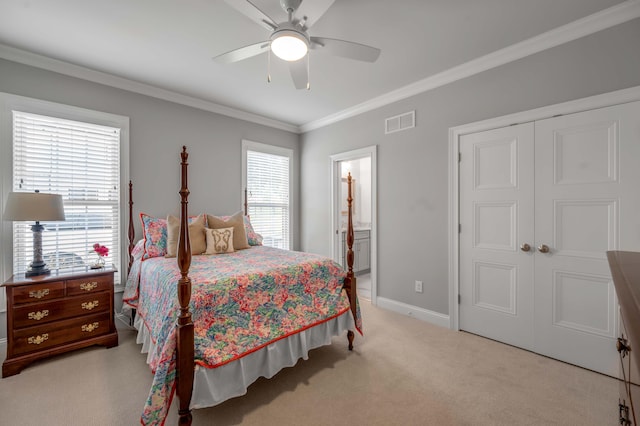 bedroom with visible vents, baseboards, light colored carpet, ornamental molding, and a closet