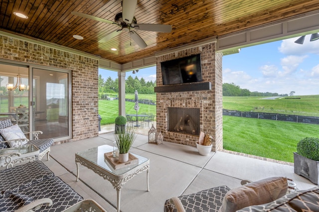 exterior space with wood ceiling, an outdoor brick fireplace, brick wall, and ceiling fan