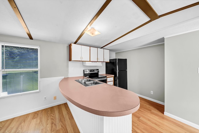 kitchen featuring black fridge, sink, light wood-type flooring, and white cabinets