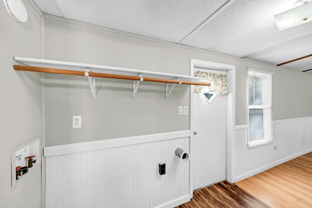 clothes washing area with hardwood / wood-style flooring