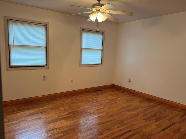 unfurnished room featuring ceiling fan and hardwood / wood-style floors