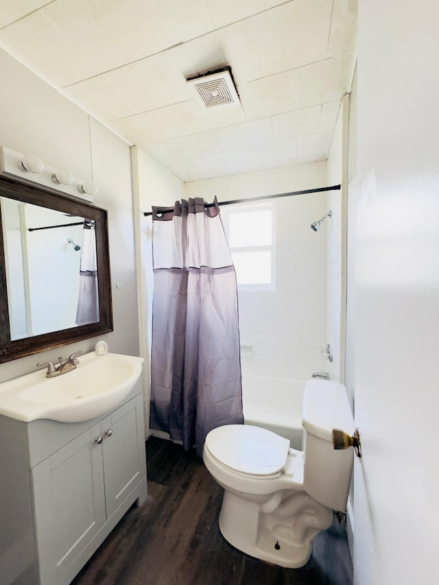 full bathroom featuring shower / bath combo with shower curtain, vanity, wood-type flooring, and toilet