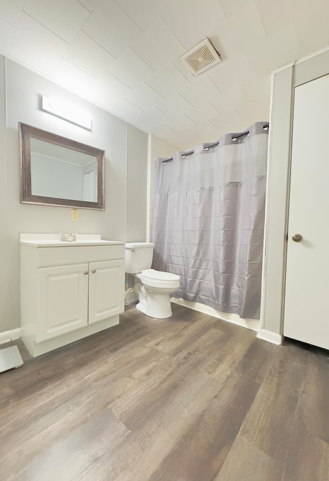 bathroom featuring vanity, hardwood / wood-style floors, and toilet