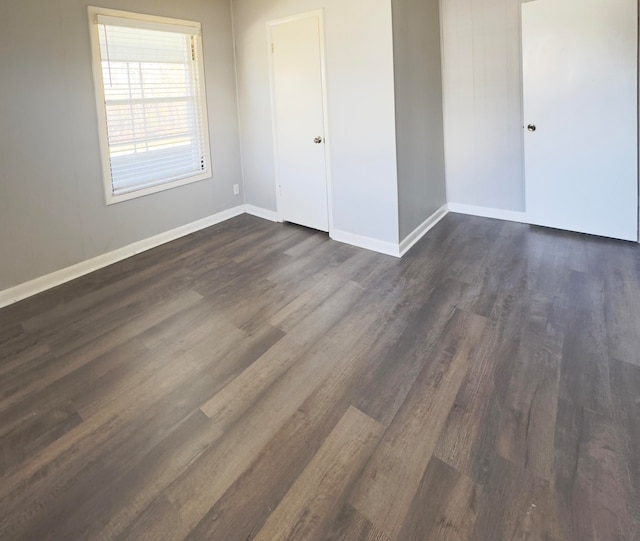 unfurnished bedroom with a closet and dark hardwood / wood-style floors