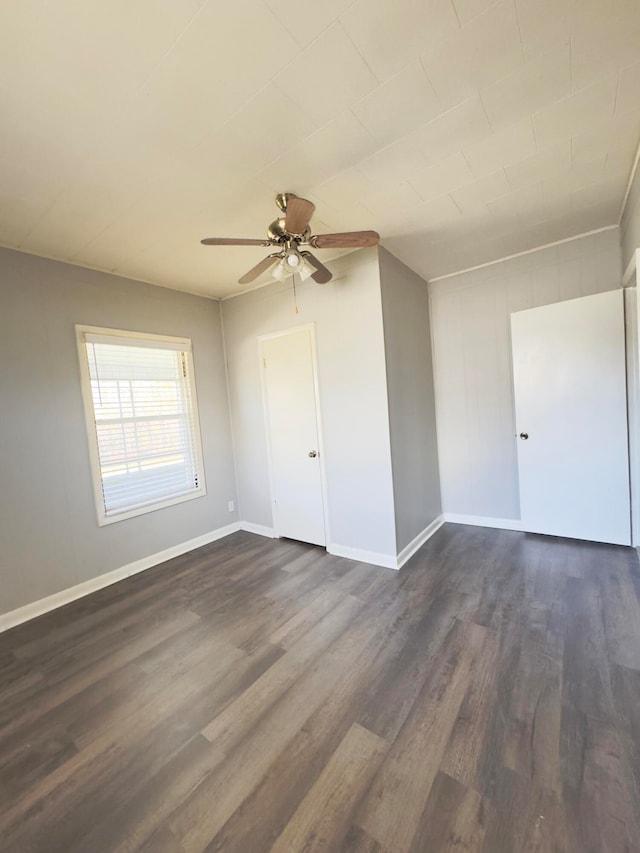 unfurnished room featuring ceiling fan and dark hardwood / wood-style flooring