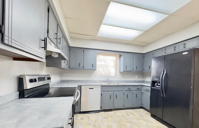 kitchen featuring a paneled ceiling, sink, gray cabinets, and stainless steel appliances