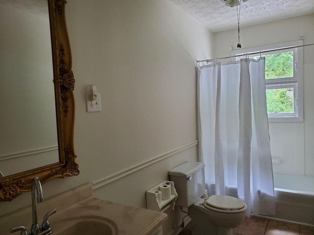 full bathroom with shower / tub combo, vanity, a textured ceiling, tile patterned floors, and toilet