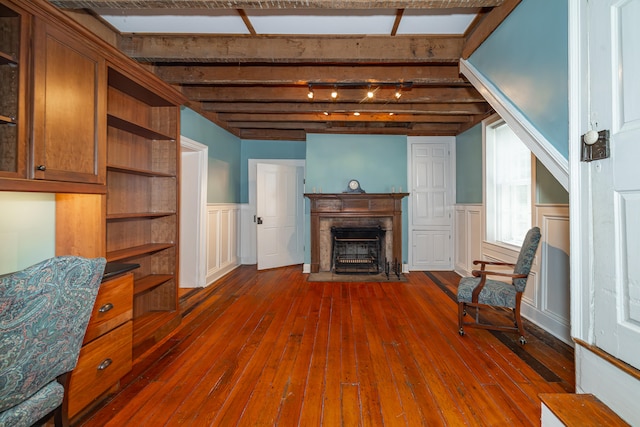 living area with dark hardwood / wood-style flooring and beamed ceiling