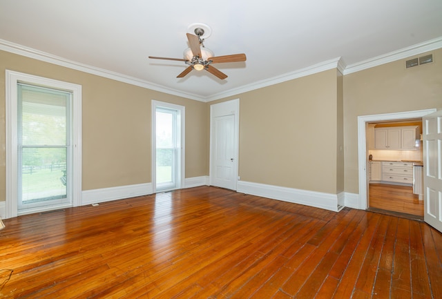 empty room featuring ceiling fan, crown molding, and hardwood / wood-style flooring