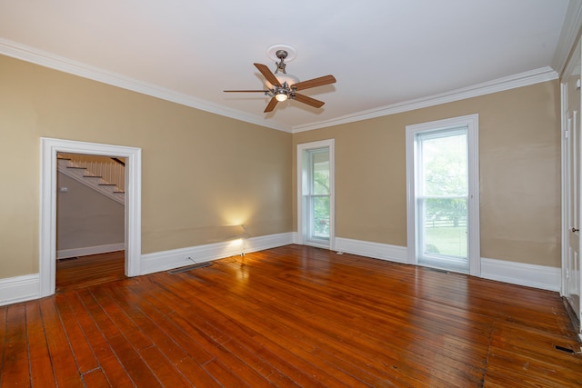 spare room featuring ceiling fan, dark wood-type flooring, and ornamental molding