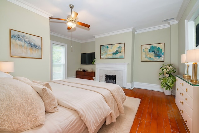 bedroom with ceiling fan, dark hardwood / wood-style flooring, and ornamental molding