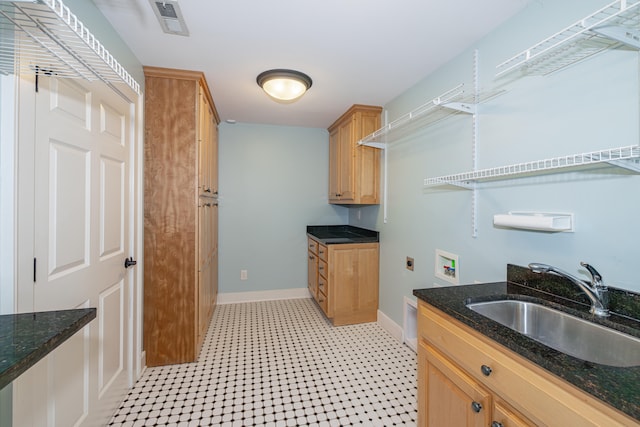 laundry area with sink, hookup for an electric dryer, hookup for a washing machine, and cabinets