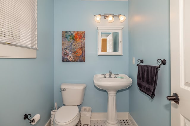 bathroom with toilet and tile patterned flooring