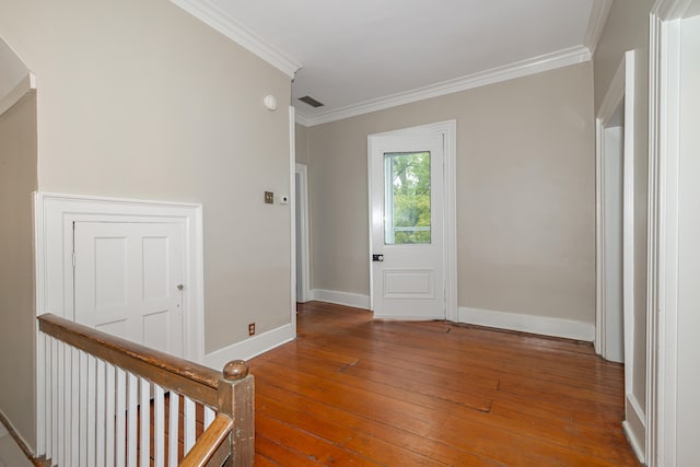 entryway featuring ornamental molding and hardwood / wood-style floors