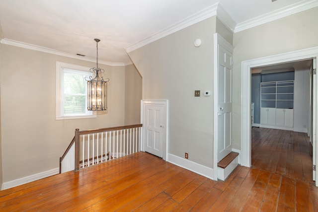 bonus room with hardwood / wood-style floors and a notable chandelier