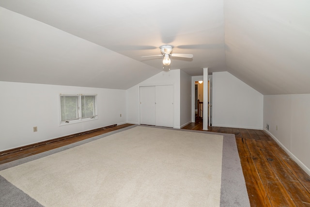 additional living space with ceiling fan, dark hardwood / wood-style flooring, and vaulted ceiling