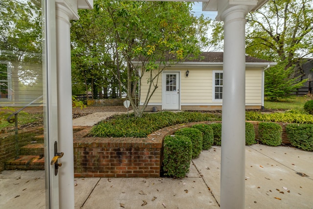 view of exterior entry featuring a patio area