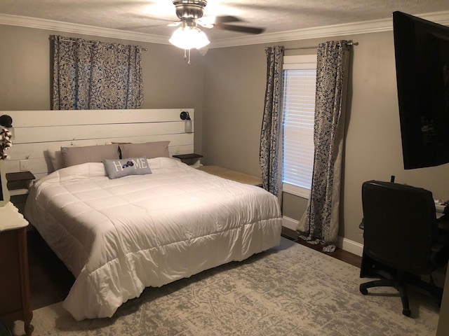 bedroom featuring ornamental molding, wood finished floors, a ceiling fan, and baseboards