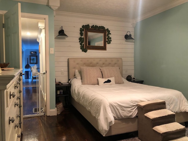 bedroom featuring ornamental molding and dark wood finished floors