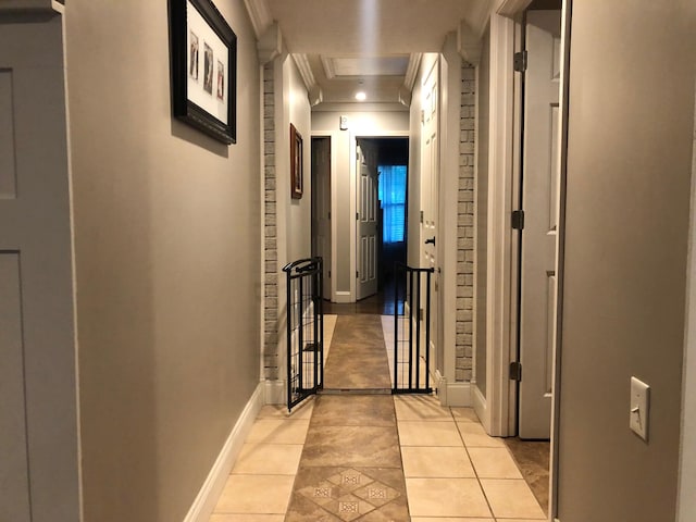 hall with light tile patterned floors, ornamental molding, recessed lighting, and baseboards