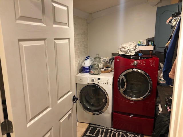 clothes washing area featuring laundry area and washer and clothes dryer