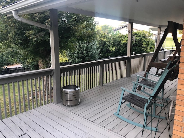 wooden deck with fence and a lawn