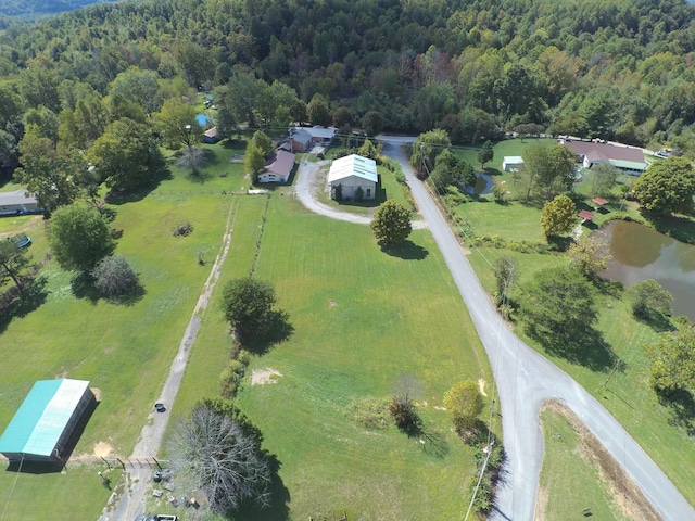 bird's eye view with a wooded view