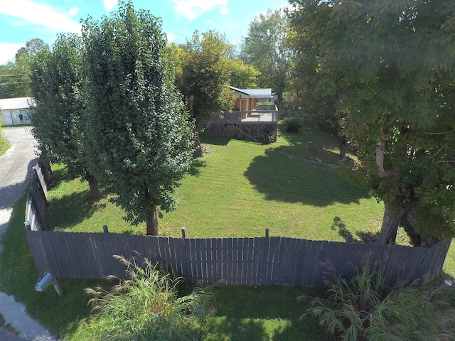 view of yard featuring fence and a wooden deck